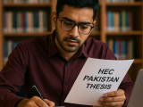 Pakistani student working on HEC Pakistan thesis with books, laptop, and research papers in a university library setting, representing academic excellence and Qundeel.com’s professional thesis writing guidance.